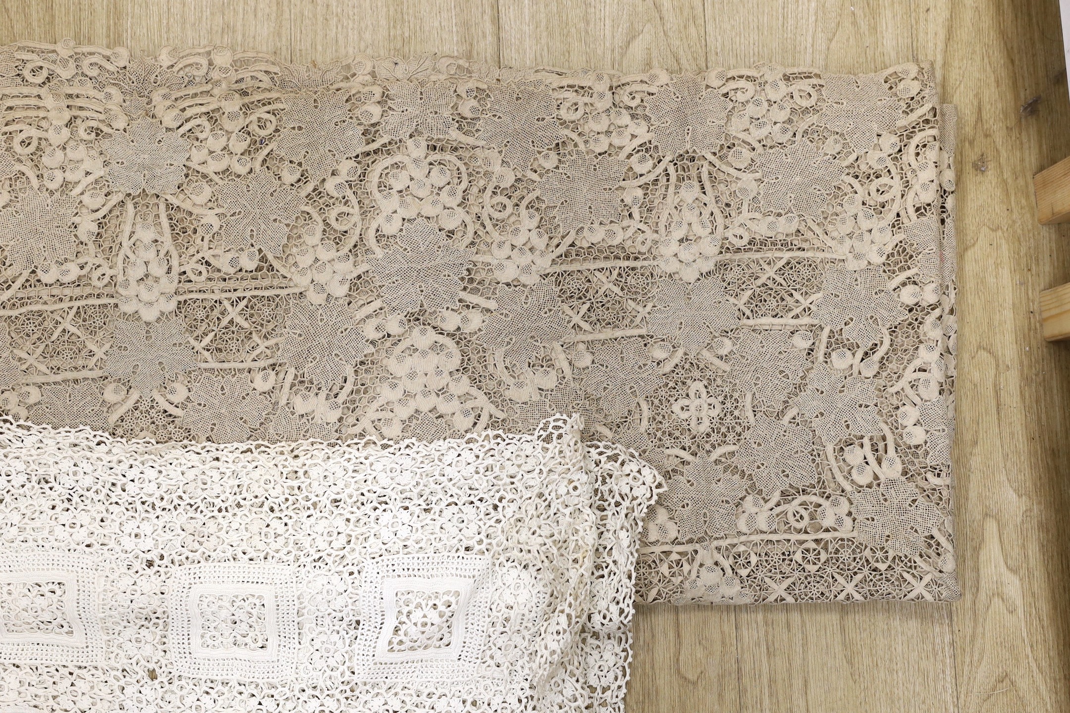 An large ecru continental hand worked table cloth and smaller linen cloth with a deep crochet edge, large cloth 232cms long x 186cms wide